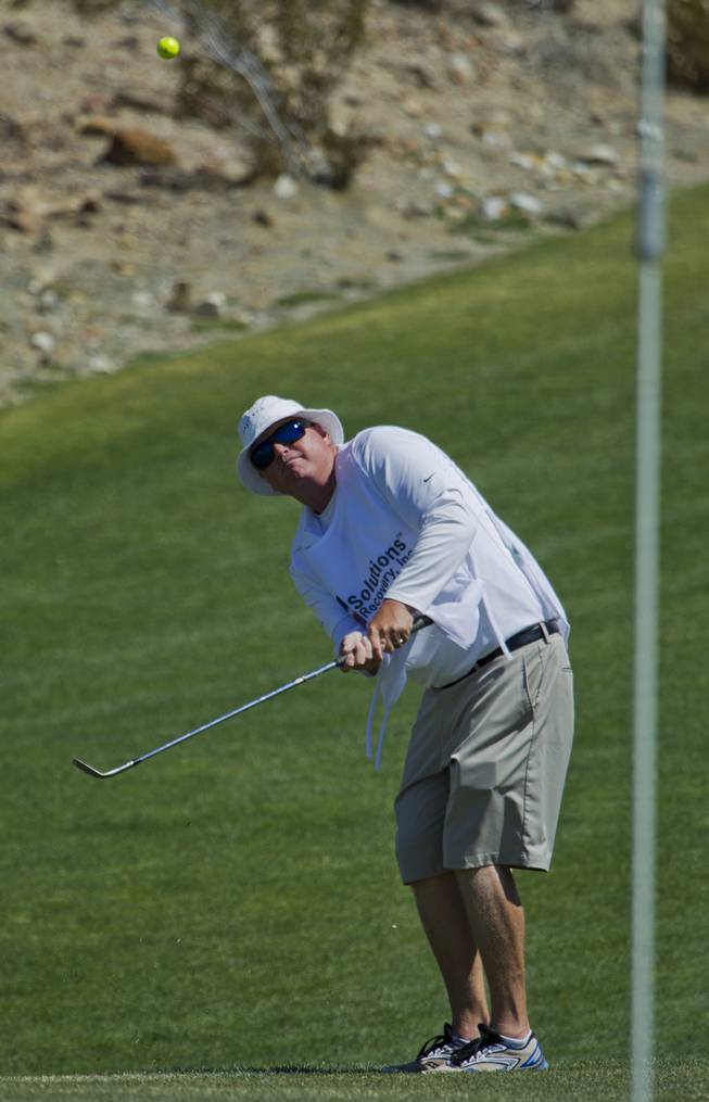 Caddy Bryan Schlosser shows how it's done as HELP of Southern Nevada hosts its 20th Annual Golfers Roundup at Cascata Golf Course in Boulder City on Tuesday, June 24, 2014.