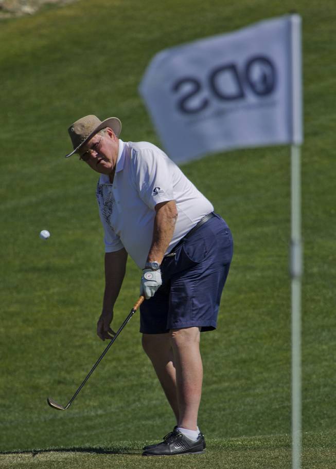 Cary Fisher chips the ball to the green as HELP of Southern Nevada hosts its 20th Annual Golfers Roundup at Cascata Golf Course in Boulder City on Tuesday, June 24, 2014.