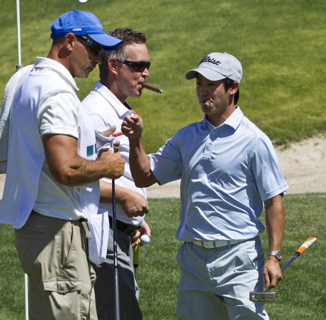 Dan Lai (right) celebrates a great putt with teammates as HELP of Southern Nevada hosts its 20th Annual Golfers Roundup at Cascata Golf Course in Boulder City on Tuesday, June 24, 2014.