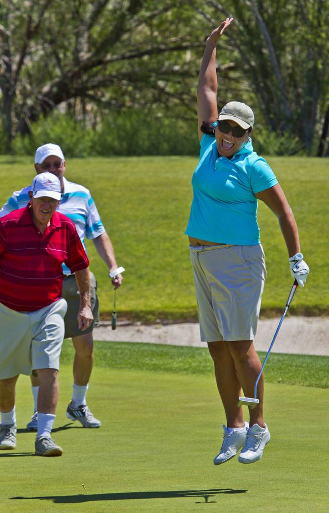Fuilala Riley celebrates after sinking a great putt as HELP of Southern Nevada hosts its 20th Annual Golfers Roundup at Cascata Golf Course in Boulder City on Tuesday, June 24, 2014.