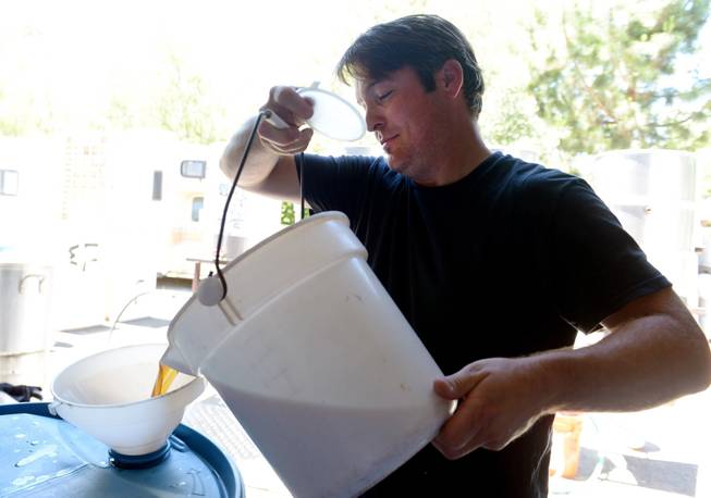 Army veteran Eric Johnson, of Fremont, Calif., pours an Amber Ale at Uncle Sam&apos;s Misguided Brewery in Livermore, Calif., on Monday, May 26, 2014. The brewery is run by fellow veterans and co-owners Josh Laine and Fara Eve Barnes.