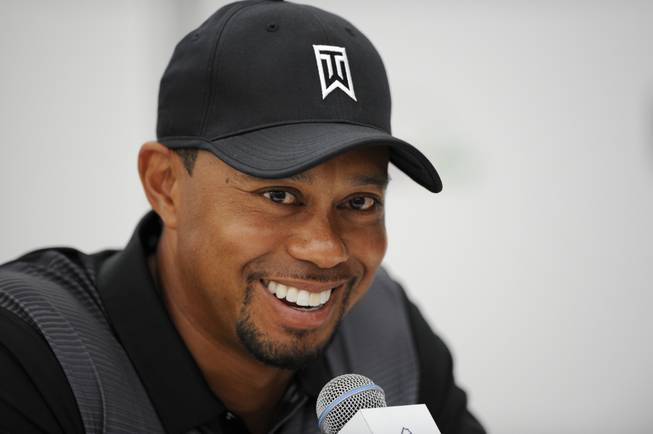 Tiger Woods smiles at a press conference at the Quicken Loans National golf tournament, Tuesday, June 24, 2014, in Bethesda, Md.