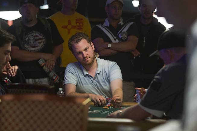 Poker player Scott Seiver, center, competes in the $50,000 World Series of Poker's Players' Championship at the Rio Wednesday, June 25, 2014.