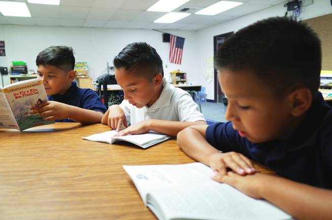 Cortez Elementary School teacher Shasta Thompson reads with third graders (l-r) Uziel Umana, 9; Rafael Lucio, 9; and Reily Armenta, 8; on Monday, June 22, 2014. Cortez is one of 14 "Zoom Schools" in Clark County that is receiving 17 additional days of school this year to help English-language learner students retain their literacy skills over the summer.                                                             