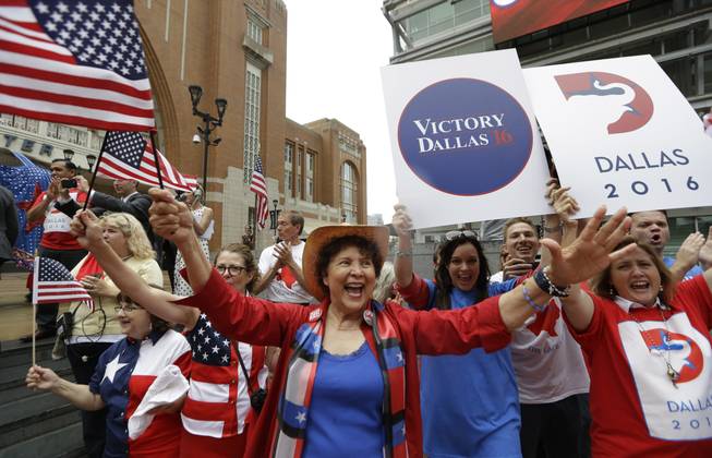Republican supporters cheer outside the American Airlines Center during a visit by members of the Republican National Committee scouting a 2016 Convention host site in Dallas, Thursday, June 12, 2014.