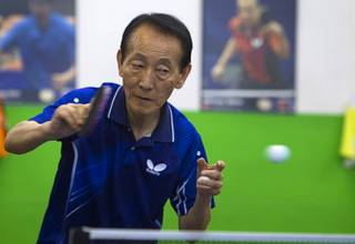 Jong Jin Lee, 73, returns a ball during a lesson at the Nevada Table Tennis Center, 4063 Renate Dr. (Chinatown Mall), Wednesday, June 25, 2014.