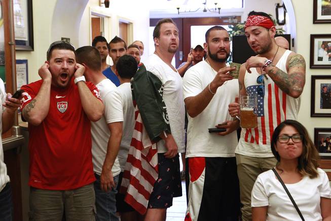 Soccer fans watch televisions at the Hofbrauhaus as the United States takes on Germany in their Group G game at the World Cup in Brazil Thursday, June 26, 2014.
