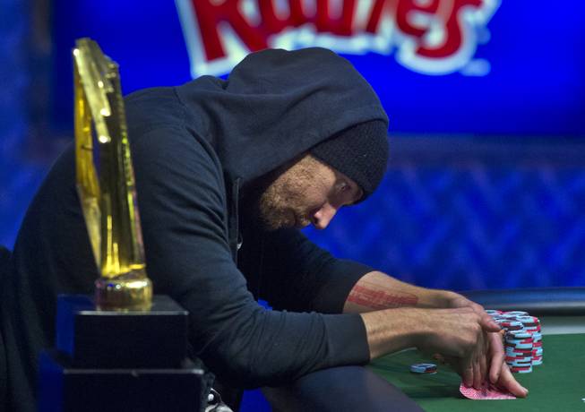 WSOP player Brandon Shack-Harris takes a peek at his cards during the Poker Players Championship final table of professional poker players at the Rio on Thursday, June 26, 2014.