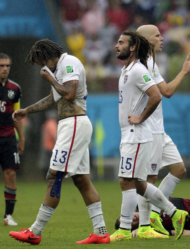 United States' Jermaine Jones (13), Kyle Beckerman (15) and Michael Bradley, far right, walk over the pitch during the group G World Cup soccer match between the USA and Germany at the Arena Pernambuco in Recife, Brazil, Thursday, June 26, 2014. 