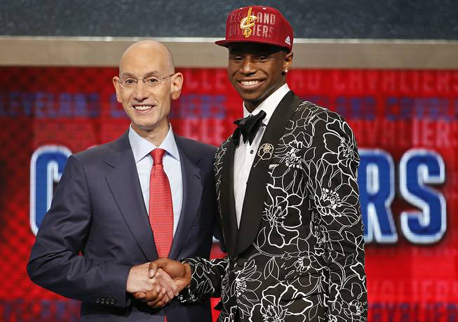 NBA Commissioner Adam Silver, left, congratulates Andrew Wiggins of Kansas who was selected by the Cleveland Cavaliers as the number one pick in the 2014 NBA draft, Thursday, June 26, 2014, in New York. 