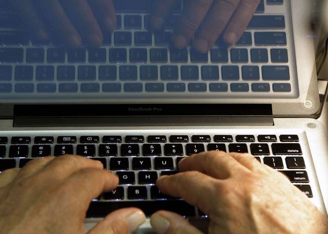 In this Feb. 27, 2013, photo illustration, hands type on a computer keyboard in Los Angeles. Frustration over passwords is as common across the age brackets.