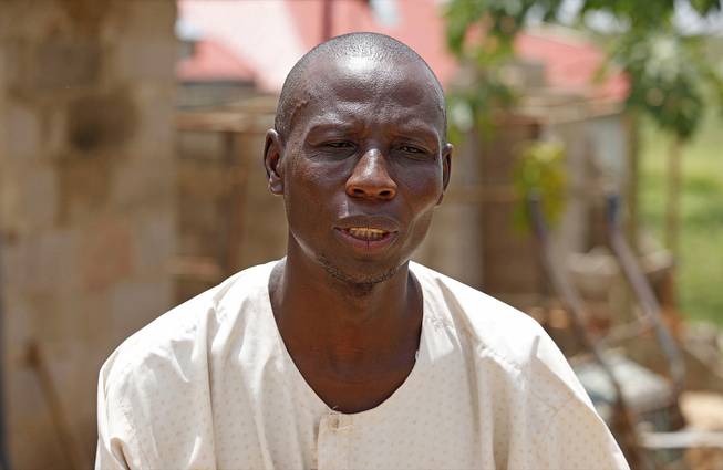 In this Monday, June 2, 2014, photo, Haruna Abdullahi, the father of Maimuna Abdullahi, speaks to a journalist outside his home in Kaduna, Nigeria. 