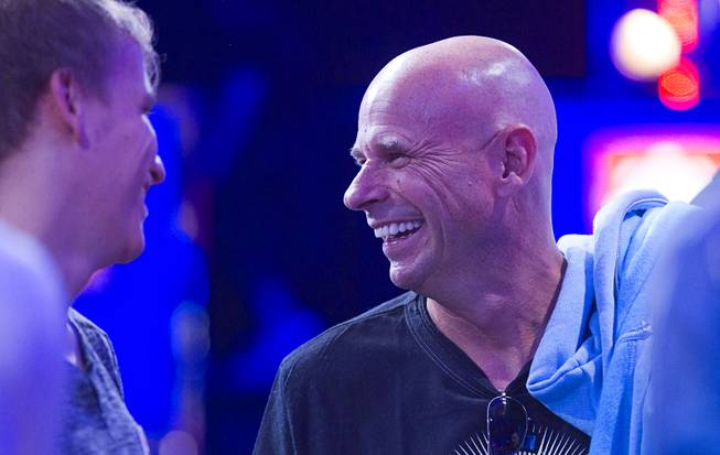 Cirque du Soleil cofounder Guy Laliberte, right, talks with other players as they wait for the start of the Big One for One Drop, a $1,000,000 buy-in No-Limit Hold'em charity poker tournament, at the Rio Sunday, June 26, 2014. The $1 million buy-in is the largest ever for a poker event. Proceeds support One Drop projects in countries experiencing serious difficulties caused by inadequate access to water.