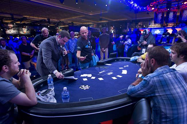 Cirque du Soleil cofounder Guy Laliberte, center, selects his seat before the start of the Big One for One Drop, a $1,000,000 buy-in No-Limit Hold'em charity poker tournament, at the Rio Sunday, June 26, 2014. The $1 million buy-in is the largest ever for a poker event. Proceeds support One Drop projects in countries experiencing serious difficulties caused by inadequate access to water.