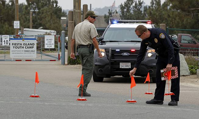 Police block the main entrance to the Fiesta Island Youth Camp, where a boy died from a self-inflicted gunshot wound at a Boy Scout camp on Monday, June 30, 2014.