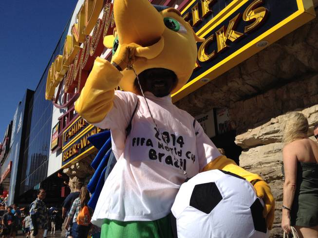 Street performer Cheikh "Louis" Diakhate, dressed as the World Cup mascot Fuleco, stands for a photo on the Las Vegas Strip on Thursday, June 26, 2014.