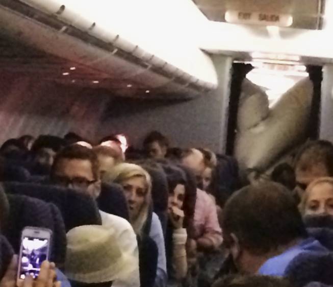 This Sunday, June 29, 2014, photo provided by Michael Schroeder shows an emergency chute after it inflated inside a United Airlines plane as it flew from Chicago to California, filling part of the cabin and forcing the pilot to make an emergency landing in Kansas.