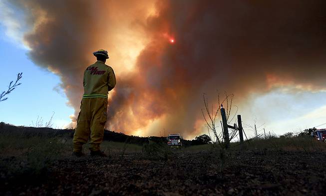 Smoke rises from the Butts Canyon Fire on Tuesday July 1, 2014, near Middletown, Calif., on the border between Lake and Napa counties. Crews are battling a raging wildfire that has burned more than 2,500 acres, damaged five structures and prompted mandatory evacuations. 