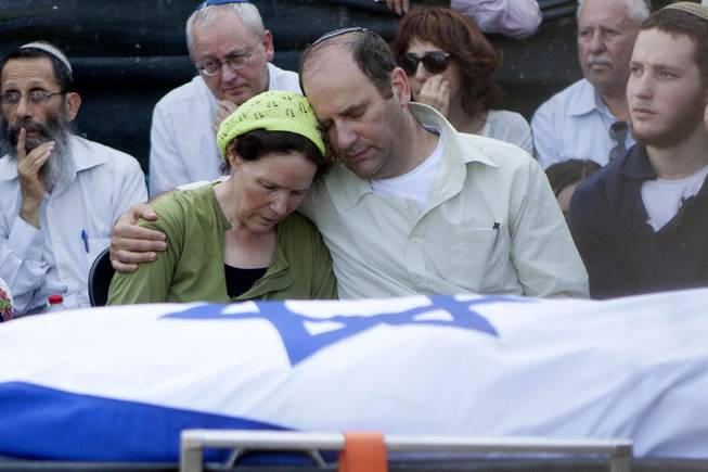Avi and Rachel Fraenkel embrace during the funeral of their son, Naftali, a 16-year-old with dual Israeli-American citizenship, in the West Bank Jewish settlement of Nof Ayalon, Tuesday, July 1, 2014.