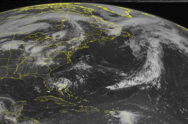 This NOAA satellite image taken Monday, June 30, 2014 at 10:45 AM EDT shows swirl of clouds trying to organize around a center of low pressure that may develop into a tropical depression soon off the eastern Florida Coast with rain and thunderstorms.