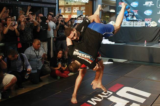 Chris Weidman throws Gian Villante during the open workout for UFC 175 Wednesday, July 2, 2014 at the Fashion Show Mall.