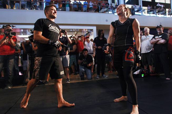 Alexis Davis and Flavio Meier laugh during the open workout for UFC 175 on Wednesday, July 2, 2014, at Fashion Show Mall.