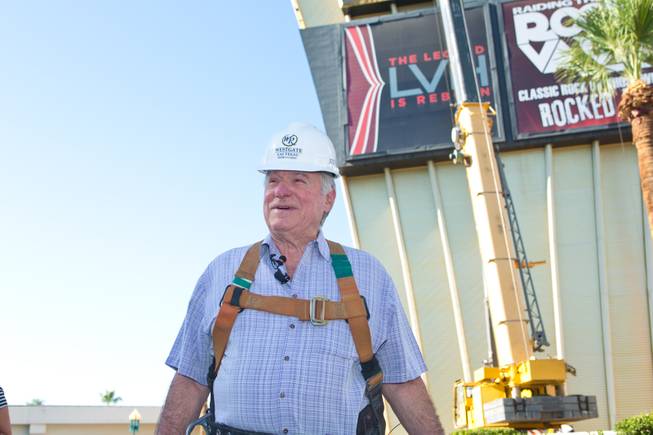 David Siegel, Founder and CEO of Westgate Resorts, suits up in a protective harness before being hoisted up over 200 feet to remove the LVH letters off their newly purchased property, Tuesday July 1, 2014.