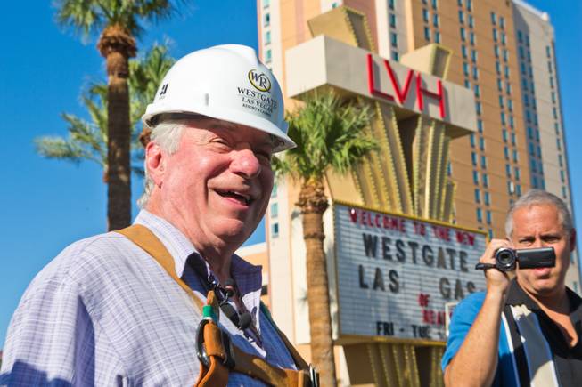 David Siegel, founder and CEO of Westgate Resorts, talks with media before being hoisted more than 200 feet to remove the LVH letters off his newly purchased property Tuesday, July 1, 2014, in Las Vegas.