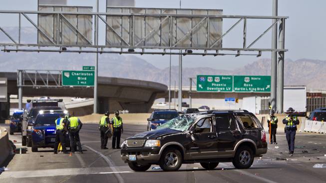 Las Vegas Metro Police continue to work the scene of a fatal car crash on the I-15 just north of the I-95 interchange on Wednesday, July 2, 2014.