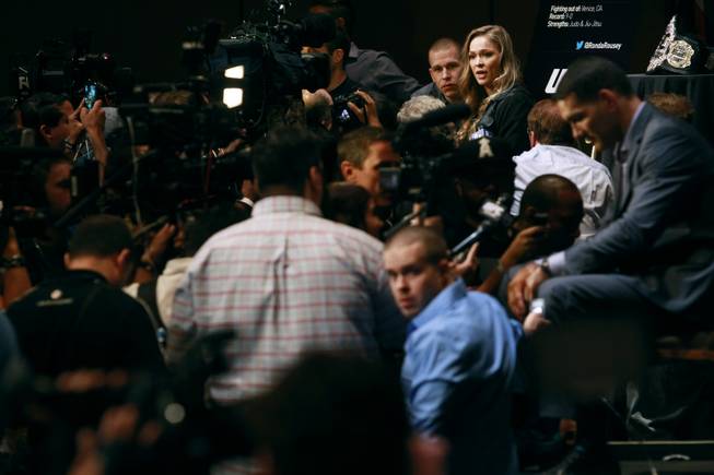 UFC women's bantamweight champion Ronda Rousey is surrounded by cameras and reporters during a media availability in advance of UFC 175 Thursday, July 3, 2014 at Mandalay Bay.