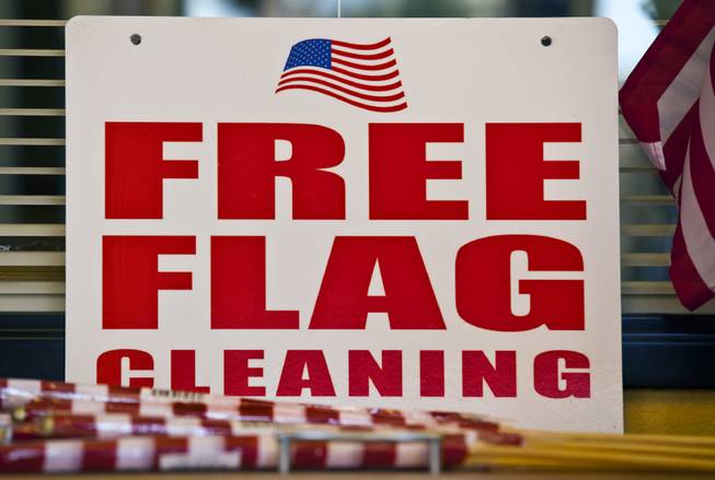 Mahamed Youssouf as owner of the Green Cleaners Alteration Center is giving away 500 flags and cleaning flags for free in honor of the Fourth of July on Wednesday, July 3, 2014.