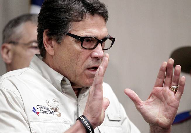 Texas Gov. Rick Perry talks to the media Monday, June 23, 2014, in Weslaco, Texas, after touring the McAllen Border Patrol station. Perry said that the border is not secure, adding, "This is an absolute humanitarian catastrophe waiting to happen." 