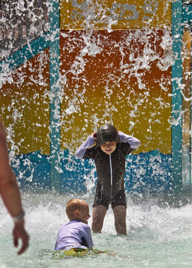 A bucket full of water is dumped on kids as they enjoy the Cowabunga Kids Cove during opening day at Cowabunga Bay on Friday, July 4, 2014.  L.E. Baskow