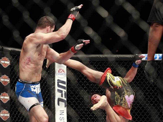 Lyoto Machida misses Chris Weidman with a flying kick during their fight at UFC 175 at the Mandalay Bay Events Center Saturday, July 5, 2014. Weidman won a unanimous decision to retain his middleweight belt.