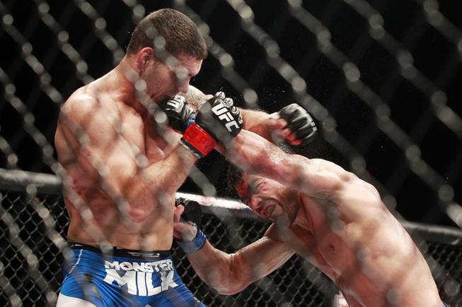 Chris Weidman gets hit with a left by Lyoto Machida during their fight at UFC 175 at the Mandalay Bay Events Center Saturday, July 5, 2014. Weidman won a unanimous decision to retain his middleweight belt.