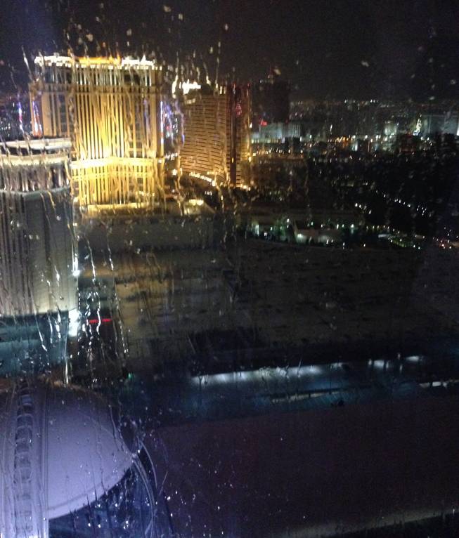 From left, the Venetian, Palazzo and Wynn can be seen through the rain from the High Roller on Friday, July 4, 2014.