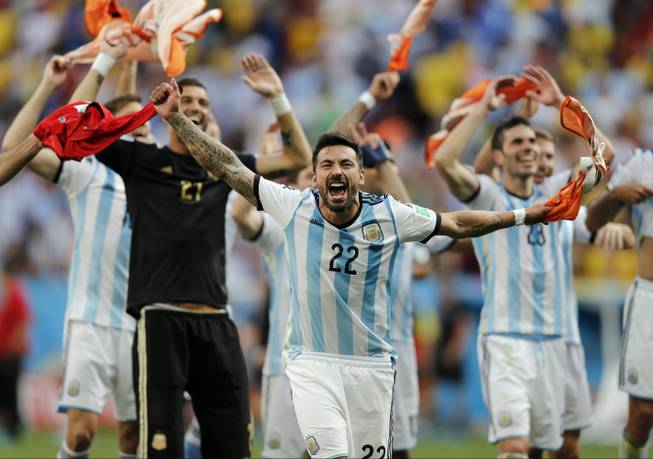 Argentina's Ezequiel Lavezzi and teammates celebrate at the end of the World Cup quarterfinal match between Argentina and Belgium at the Estadio Nacional in Brasilia, Brazil, on Saturday, July 5, 2014. Argentina won 1-0. 