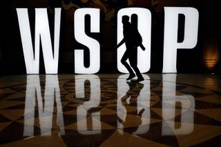 A man walks by a sign on the first day of the World Series of Poker main event Saturday, July 5, 2014 in Las Vegas. Players are vying for the $10 million first-place payout at the poker tournament. (AP Photo/John Locher)