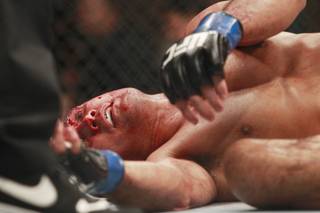 B.J. Penn rolls over after referee Herb Dean called a stop to his fight against Frankie Edgar at 