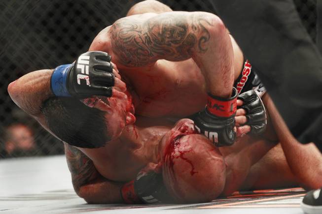 Frankie Edgar pounds B.J. Penn in the head during their fight at "The Ultimate Fighter" 19 finale Sunday, July 6, 2014 at the Mandalay Bay Events Center.