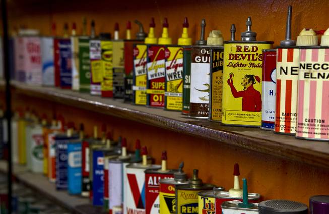 Jim Rogers is an avid collector and has a distinctive selection of old, decorative oil and fluid cans on Friday, July 4, 2014.  L.E. Baskow