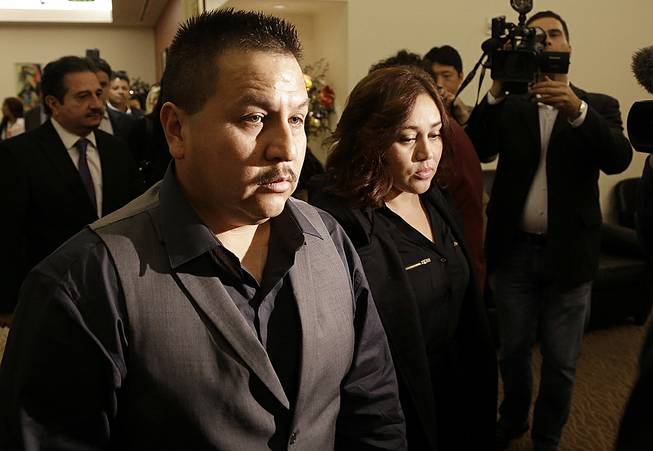 Rodrigo Lopez, left, and Sujay Cruz, parents of Andy Lopez, walk to a news conference in San Francisco, Nov. 4, 2013. 
