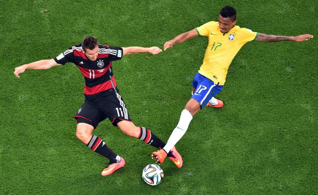 Germany's Miroslav Klose, left, and Brazil's Luiz Gustavo go for the ball during the World Cup semifinal soccer match between Brazil and Germany at the Mineirao Stadium in Belo Horizonte, Brazil, Tuesday, July 8, 2014. (AP Photo/Francois Xavier Marit, Pool)