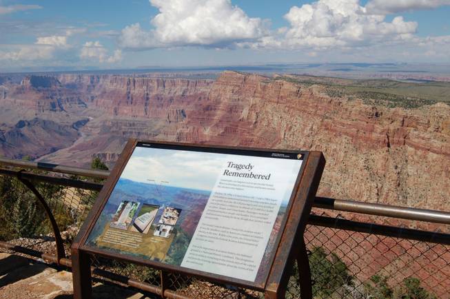 This Sept. 12, 2013, photo released by the National Park Service shows a National Historical Landmark plate overlooking the east end of the Grand Canyon in Arizona where two commercial airplanes crashed on June 30, 1956.