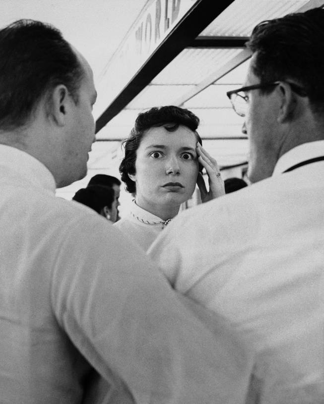 Mrs. Robert E. Lacy of St. Louis pauses with a look of stunned horror in St. Louis, July 1, 1956 after receiving word that a TWA airliner on which her half sister, Bessie Whitman of San Francisco, was traveling for a visit. The plane's wreckage was found later in the Grand Canyon. Mrs. Lacy and friends were awaiting the plane's arrival at the St. Louis Municipal Airport. "I feel like I'm going to faint", she said. Mrs. Lacy was helped to a rear office at the airport before going home. 