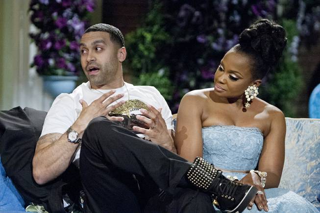 This 2014 image released by Bravo shows Apollo Nida and his wife Phaedra Parks, cast members of “The Real Housewives of Atlanta,” during the taping of a reunion special in Atlanta.
