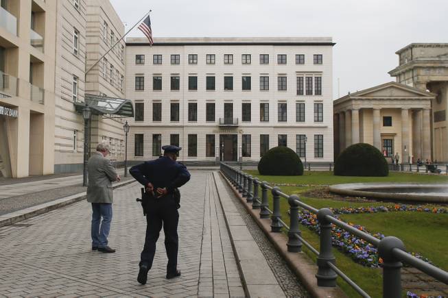 In this April 16, 2013, file photo, United States security officers patrol in front of the U.S. embassy in Berlin, Germany.