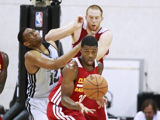 Cleveland Center Alex Kirk pushes away Milwaukee forward Jabari Parker while Cleveland guard Carrick Felix pulls in a rebound during their NBA Summer League game Friday, July 11, 2014 at the Cox Pavilion.