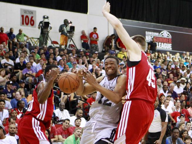 Milwaukee forward Jabari Parker loses the ball while trying to drive past Cleveland forward Jack Cooley during their NBA Summer League game Friday, July 11, 2014 at the Cox Pavilion.