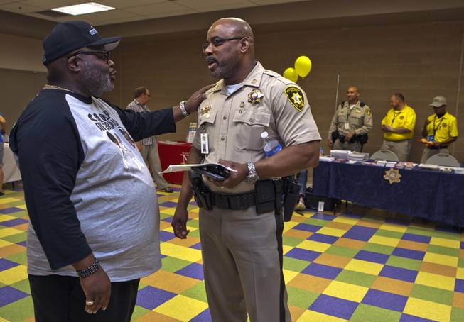 Melvin "Beetle" Ennis chats with longtime friend Capt. Will Scott of the Bolden Area Command on Saturday, June 28, 2014.  They joined many others at a Stop the Violence event at the Pearson Community Center in response to the recent spate of homicides in that area.